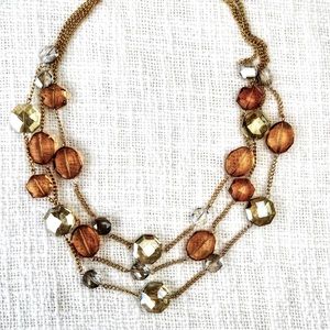NWOT Chico’s gold and amber color gem necklace. Triple layer.